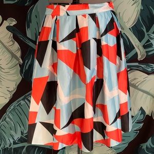Satin finish geometric pleated skirt